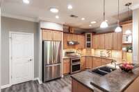 Equipped with stainless appliances, including a gas stove, this kitchen is both functional and stylish.