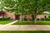 Welcoming covered entry with room for seating and seasonal decor, offering shelter and style.