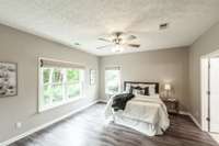 Featuring luxury vinyl plank flooring and large windows that fill the room with natural light, this spacious retreat offers comfort and style.