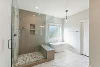 Master shower with built in bench and frameless door