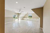 A generously-sized bonus room with a sleek half bath, designed to accommodate multiple TV setups!
