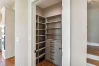 Walk-in pantry with custom shelving and drawers