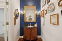 The beautifully appointed powder room is just off the foyer entry