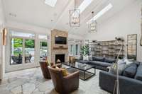 Overflowing with natural light, this magazine worthy family room is likely to become your favorite room in the house!  The striking vaulted ceiling, floor to ceiling stone fireplace and oversized windows enhance this exceptional space!