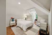 This upper level bedroom overlooks the rear of the house and the lovely pool area.