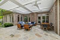 The sunroom and kitchen breakfast nook both open to this space, allowing for seamless transition from inside to outdoors and an ease of flow for entertaining