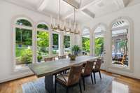 Perfectly blending the outdoors with inside, this beautifully designed kitchen dining nook is the perfect place to begin the day or enjoy a casual evening meal.  The coffered ceiling and designer light fixture are elegant features.
