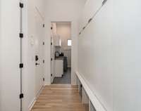 A custom built-in storage wall offers the perfect place to organize all your daily essentials with style and ease