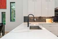 The subway tile backsplash offers a modern touch accenting the culinary space