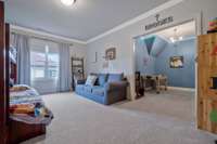 Upstairs bedroom features an extra sitting room in addition to its very own walk-in closet.