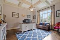 Formal office with french doors offers a private space for work use.