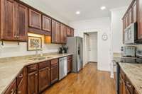Classic kitchen with solid wood cabinetry, granite counters, stainless appliances, and a functional layout for home chefs.