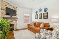 Warm and inviting den with a fireplace and natural light—perfect for movie nights or relaxed gatherings.
