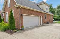 Side-entry 2-car garage with flat driveway.