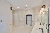 Looks like the camera guy is in the whirlpool tub! If you prefer a shower, there is one straight ahead. The second walk in closet is on the left and the door to the right of the shower leads to the "powder" room.