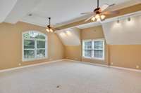The bonus room is located above the garage. It has track lighting added to the far side.