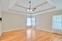 The primary bedroom is located off the kitchen. It has an impressive trey ceiling.