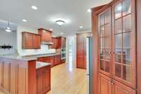 You will find an abundance of cabinet space including a corner hutch with glass doors and illumination.