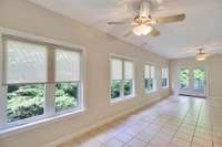 The sunroom is spacious and provides a great view to your private partially wooded back yard.