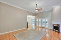From the foyer into the living room. Large open doorway leads to the kitchen dining nook and a 2nd set of French doors into the sunroom.