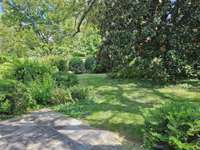 In addition to a spacious terrace, there is green as well. Mature planting including at least three beautiful magnolia trees.
