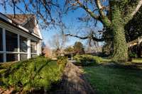 View of screened porch and shade tree
