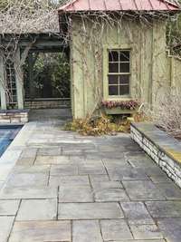 Pool house contains a half bath and storage. And like the pergola will be deliciously green come spring.