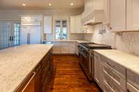 Fresh white and stainless-a classic kitchen color combo. Dacor double oven, pot filler, Subzero paneled french door refrigerator, dishwasher