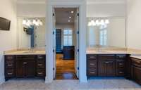 Vanities separated by entrance to the walk-in-closet
