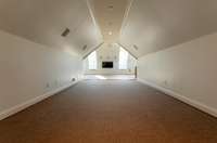 At the top of the stairs, a hallway leads to media room & bedroom 5. Hallway is wide for custom built-ins