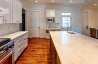 A view from the kitchen toward the friends and family exterior door and the pantry. Dacor microwave & warming drawer