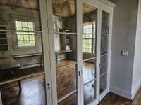 Mirrored doors attractively conceal office storage