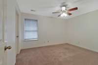 One of the two large bedrooms upstairs, with a spacious closet and ceiling fan!