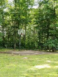 Nestled toward the rear of the backyard is this fun surprise! A concrete pad and basketball goal make for fun outdoor entertainment or a spot to perfect your basketball skills!