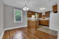 Spacious eat-in area leads into a retro-style kitchen with solid wood cabinetry and ample counter space.