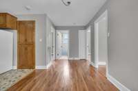 Classic layout with original hardwood floors, fresh paint, and easy access to bedrooms, bathroom, and storage.