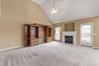 A spacious living room with vaulted ceilings and a gas fireplace