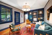 Den View looks into Kitchen and Screened Porch Bookcases are a nice addition