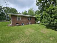 view of house side and basement door entrance