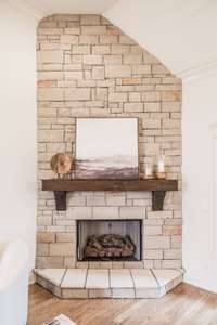 Floor to ceiling gas fireplace. Behind the painting is a plug and mounting space for a TV if desired.