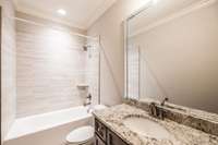 Shared full bathroom for bedrooms 2 and 3 on main floor. Metal tub.