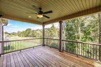 Back covered deck with trees in bloom. Community fire pit is three houses down on the left.