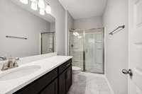 Primary Bath is Equipped with Double Vanities (not pictured), Quartz Countertops, 5' Shower Insert with Glass Door, and Upgraded Tile Flooring!