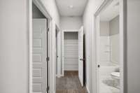 Linen Closet Conveniently Located at the end of the hall Separating Bedrooms 2 & 3 from the Secondary Bath. Secondary Bath is Equipped with Shower/Tub Combo, Quartz Countertops & Upgraded Tile Flooring!