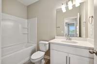 Secondary Bath equipped with Shower/Tub combo, Quarts Countertops, and is Conveniently Located across the Hall from Bedrooms 2 & 3.