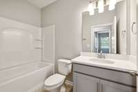 Secondary Bath is Located Across the Hall from Bedrooms 2 & 3, and is Equipped with Sower/Tub Combo, Quartz Countertops & Upgraded Tile Flooring!