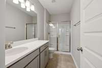 Primary Bath is Equipped with Double Vanities (not pictured), Quartz Countertops, 5' Shower Insert with Glass Door, and Upgraded Tile Flooring!