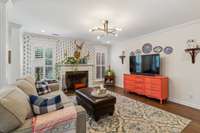 Open plan living room with gas log fireplace.