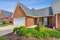 All brick townhome with beautiful mature landscaping.