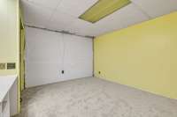 Basement Flex Room with desk built in and 1 wall unfinished by AFS Moisture Barrier.